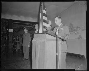 Lieut. Col. William A. Somerby Jr. at the podium swearing in U.S.A.F. recruits