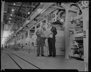 John I. Taylor, president, and William Davis Taylor, publisher, holding newspaper sheets in Boston Globe's new plant in Dorchester