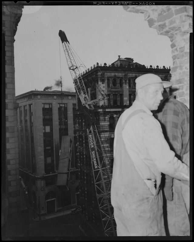 Roger Sherman crane moving an oversized item from several floors up