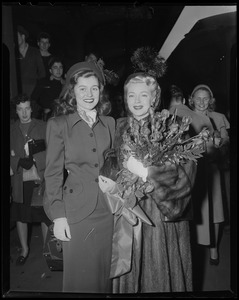 Lana Turner and a woman pose for the camera