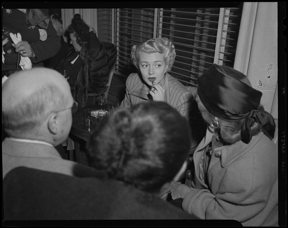 Lana Turner meeting with a group of people