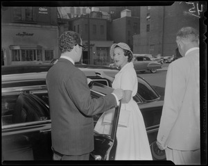 Man helping Lilian, Princess of Réthy into a vehicle