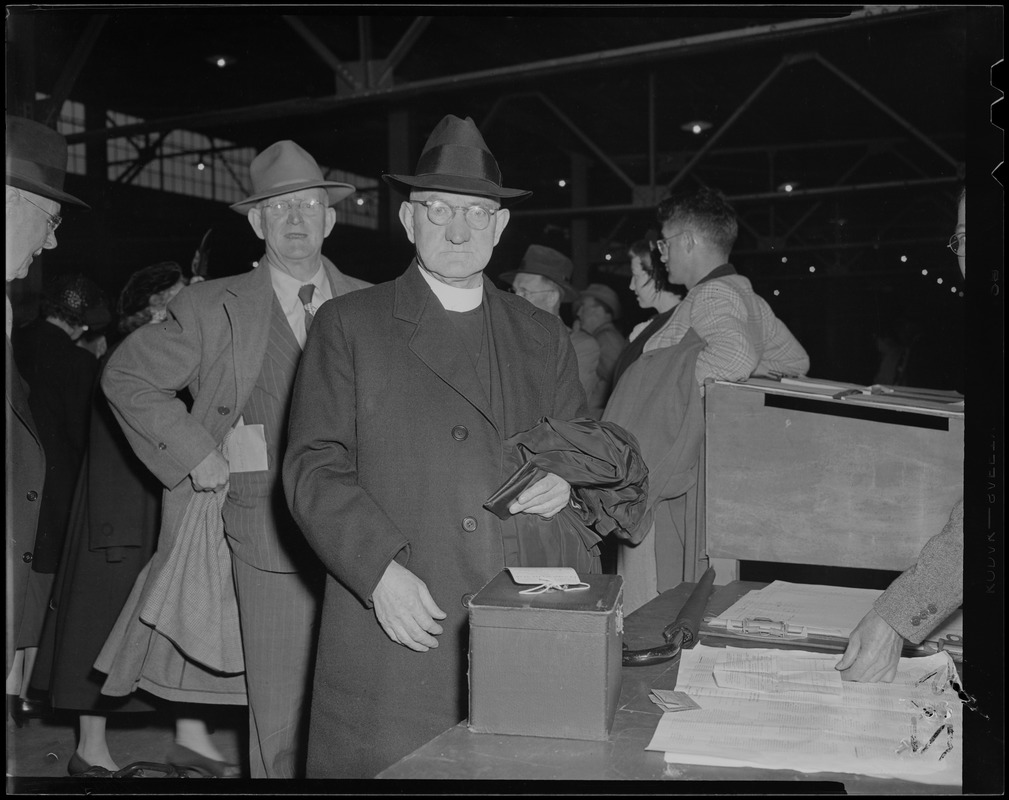 A clergyman checking in for the pilgrimage