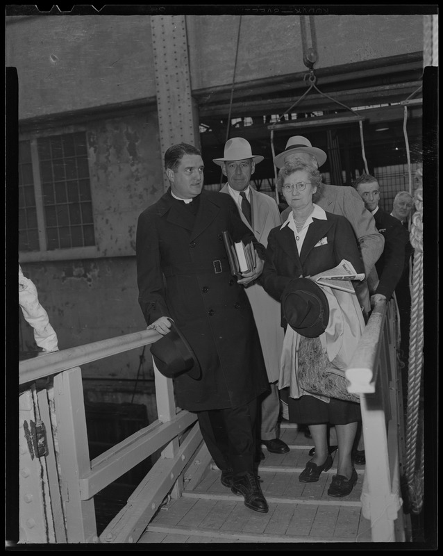 A clergyman and three others on the drawbridge