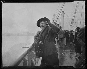 Woman on the ship deck waving