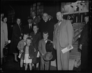 Cardinal Cushing poses with children and a man