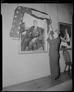Portrait of former Governor Paul Dever, which hangs in the Governor's office in the State House, is draped with an American flag by Charles N. Collatos, his former secretary and present Commr. Of Veterans Services, after news of Dever's death reached Beacon Hill