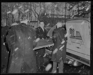 Pallbearers placing the coffin of former Governor Paul Dever into the hearse