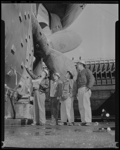 Four men look at the propellers on S.S. Princess Sophie tanker