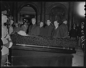 Reverend Francis Curley and George Curley, far right, with two other clergymen, paying respects to their father James M. Curley