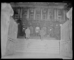 Two men walking up the stairs to the State House for the James M. Curley wake