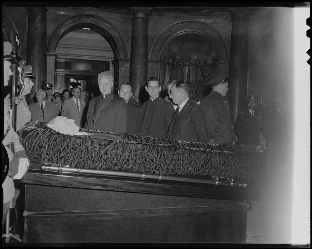 Reverend Francis Curley and George Curley, far right, with two other clergymen, paying respects to their father James M. Curley