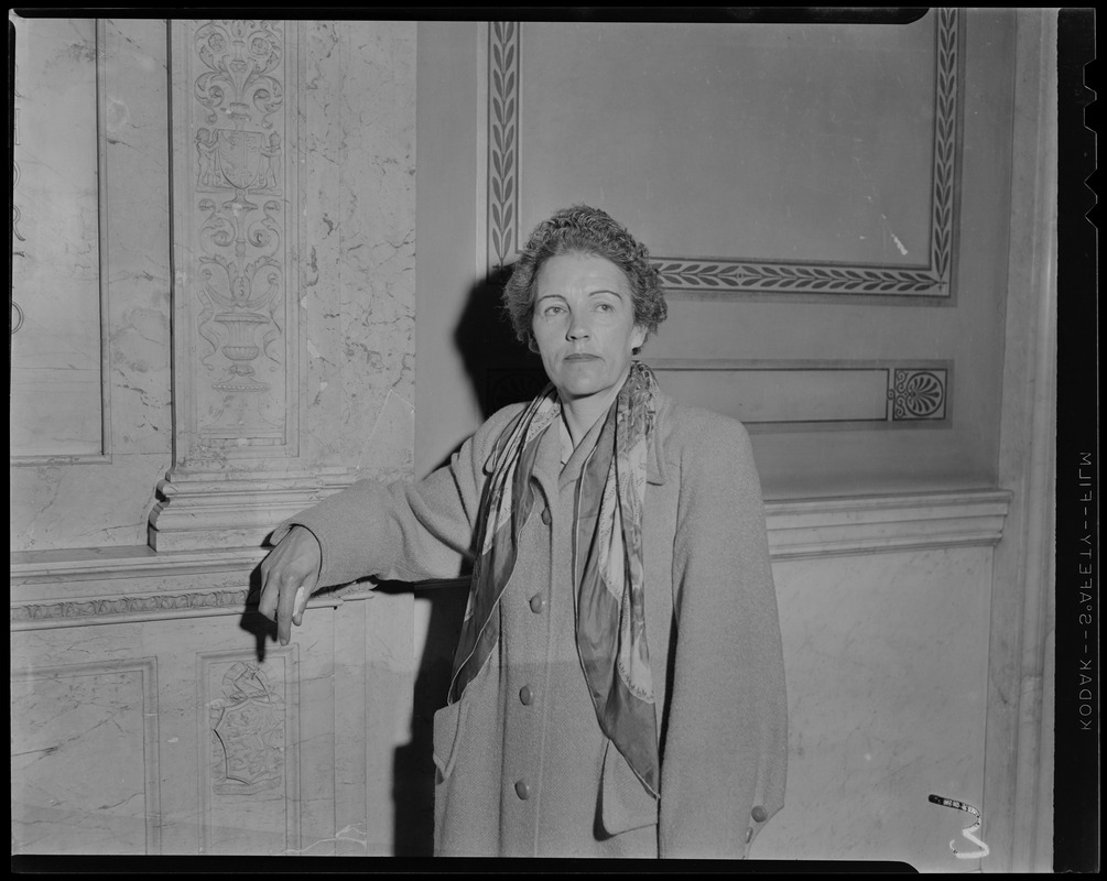 Woman standing along a wall in the State House