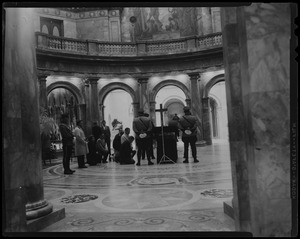 Mourners genuflecting in the Hall of Flags, beside the casket of James M. Curley