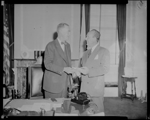Governor Herter and William Randolph Hearst Jr. exchanging books