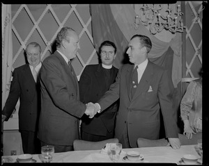 A man shaking hands with William Randolph Hearst Jr. at a reception at the Somerset Hotel
