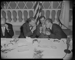 Governor Herter and William Randolph Hearst Jr. lighting cigarettes
