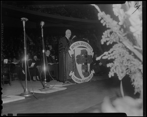 Chief Justice Earl Warren of U.S. Supreme Court is shown addressing 2704 Boston University graduates at commencement exercises at Boston Garden