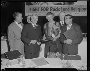 Eleanor Roosevelt standing with coach Frank Leahy of Notre Dame, far left, and Eddie Cantor, far right, and others at the Massachusetts Committee of Catholics, Protestants and Jews dinner