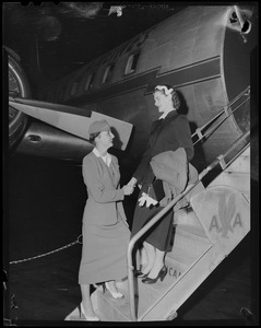 Flight Attendant Nancy Schodle shakes the hand of Mrs. Jean Smith as she boards plane for New York