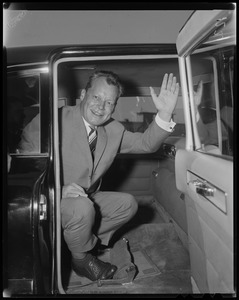 Willy Brandt, West Berlin mayor, sitting in a car waving his hand