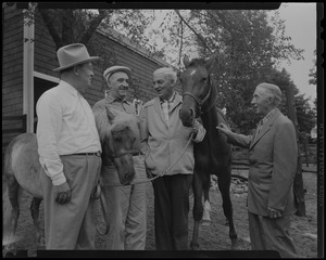 Walter Gibbons, Jimmy Jordan, Paul Wixom and one other man standing with horses