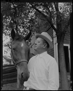 Walter Gibbons standing next to a horse, "Jake"