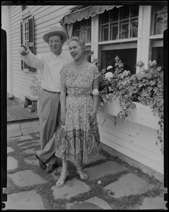 Walter and Madeline Gibbons standing outside of a house