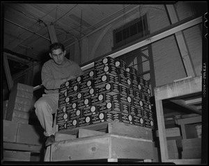 A man with a shipment of Polaroid boxes