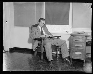 Randolph Hearst sitting in chair with a book