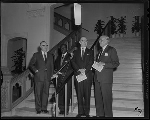 Standing in front of the microphone during ceremonies of the opening of the Hearst Lounge at Boston University are Robert Choate, Dean of the School of Fine Arts; Dean Howard Thurman of Marsh Chapel; President Harold Case, President of B.U.; and Harold G. Kern of the Hearst Corp
