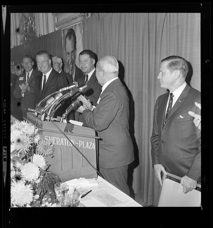 A man at the podium surrounded by GOP Vice Presidential Candidate Spiro Agnew, Sen. Edward Brooke, on left and Gov. Volpe, right