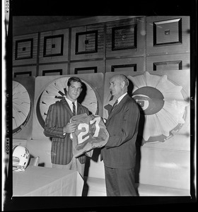 Joe Bellino with Patriots' president Bill Sullivan holding a jersey, helmet, and football after signing a contract with the Patriots the previous day
