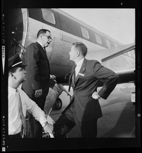 Paul Wagner, Goldwater staff member, chats with another man on airplane steps