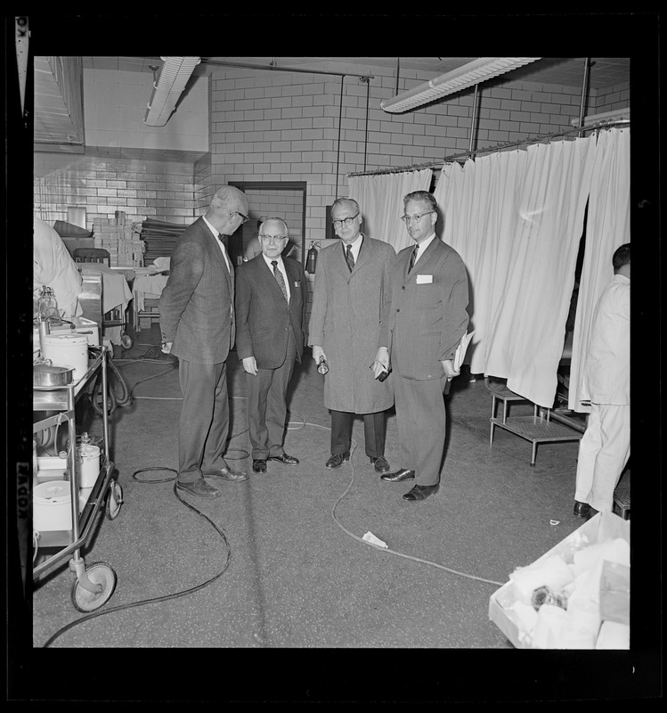 Group of four men in a hospital ward