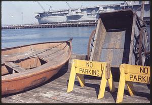 "No Parking" signs next to boat on pier
