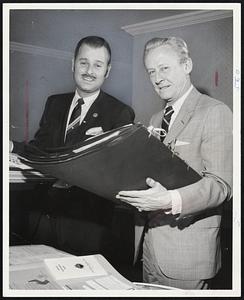 Herb Abramson (left), President of Silver Lake Dodge, Newton, receives Brand Names Foundation "Retailer of the Year award from Perine, President of Brand Names Foundation.