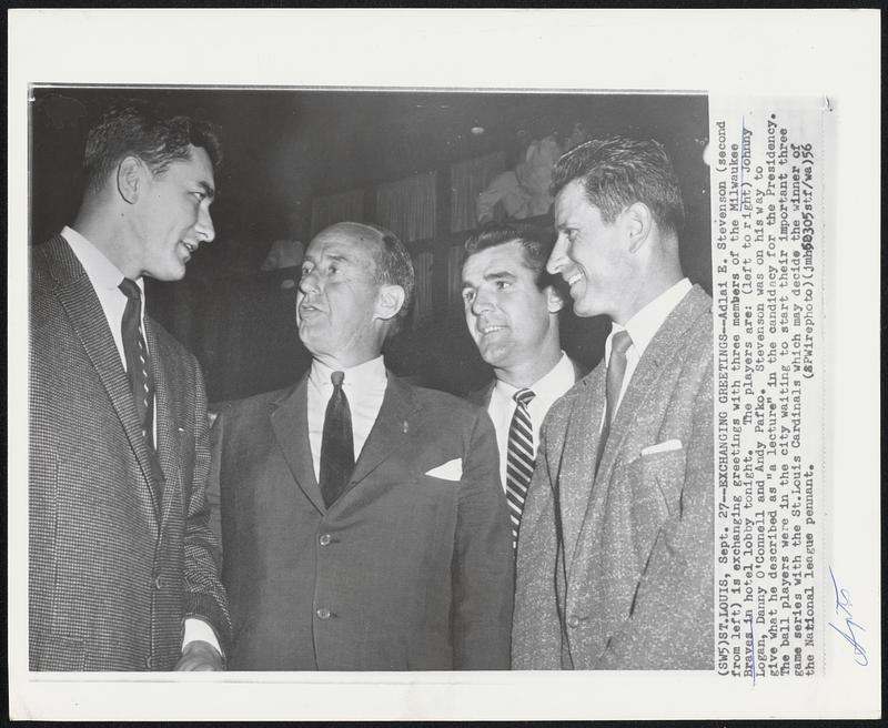 St. Louis – Exchange Greetings – Adlai E. Stevenson (second from left) is exchanging greetings with three members of the Milwaukee Braves in hotel lobby tonight. The players are: (left to right) Johnny Logan, Danny O’Connell and Andy Pafko. Stevenson was on his way to give what he described as “a lecture” in the candidacy for the Presidency. The ball players were in the city waiting to start their important three game series with the St. Louis Cardinals which may decide the winner of the National league pennant.