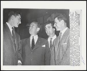 St. Louis – Exchange Greetings – Adlai E. Stevenson (second from left) is exchanging greetings with three members of the Milwaukee Braves in hotel lobby tonight. The players are: (left to right) Johnny Logan, Danny O’Connell and Andy Pafko. Stevenson was on his way to give what he described as “a lecture” in the candidacy for the Presidency. The ball players were in the city waiting to start their important three game series with the St. Louis Cardinals which may decide the winner of the National league pennant.