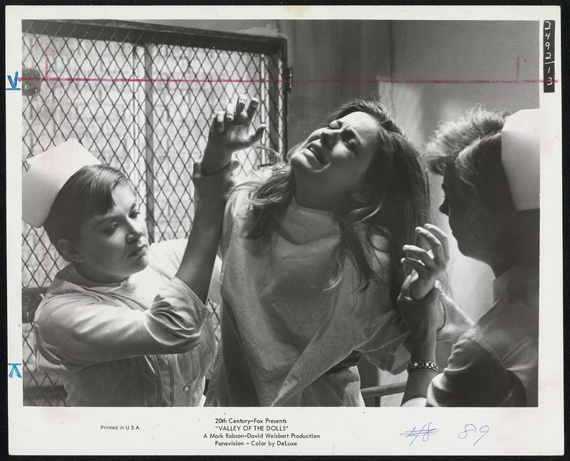 The Withdrawal--Patty Duke as Neely O'Hara writhes in agony as she struggles with nurses in a sanitarium where she is treated for drug and alcohol addiction in "Valley of the Dolls" at the Savoy.