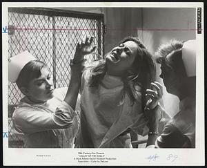 The Withdrawal--Patty Duke as Neely O'Hara writhes in agony as she struggles with nurses in a sanitarium where she is treated for drug and alcohol addiction in "Valley of the Dolls" at the Savoy.
