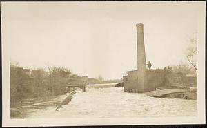 Flooded Nashua River showing Nashua River Paper co. mill, dam, destroyed Main Street bridge