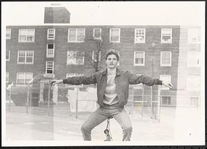 Young man balancing on a bike