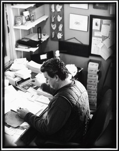 Eddie Hook calculating prices at desk