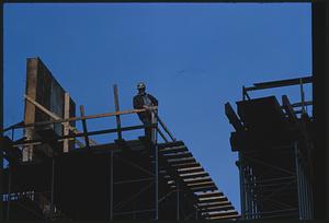 Worker on platform at construction site