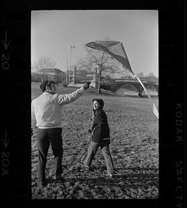 Couple flies kite by Charles River near Harvard, Brighton