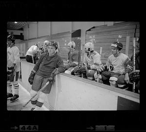 Youth hockey players gather around bench, Woburn