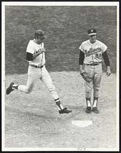 Boston Red Sox rightfielder Billy Conligliaro scores as Baltimore Orioles pitcher Pete Richart watches