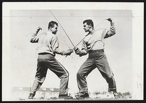 Two men crossing fencing foils