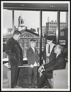 In His New Office, with view overlooking Faneuil Hall in background, Mayor White talks to three young visitors, John Doherty, Keith McInnes and Billy Doherty.